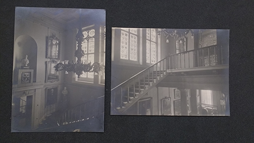 Two black and white photographs of stained glass windows next to a staircase.