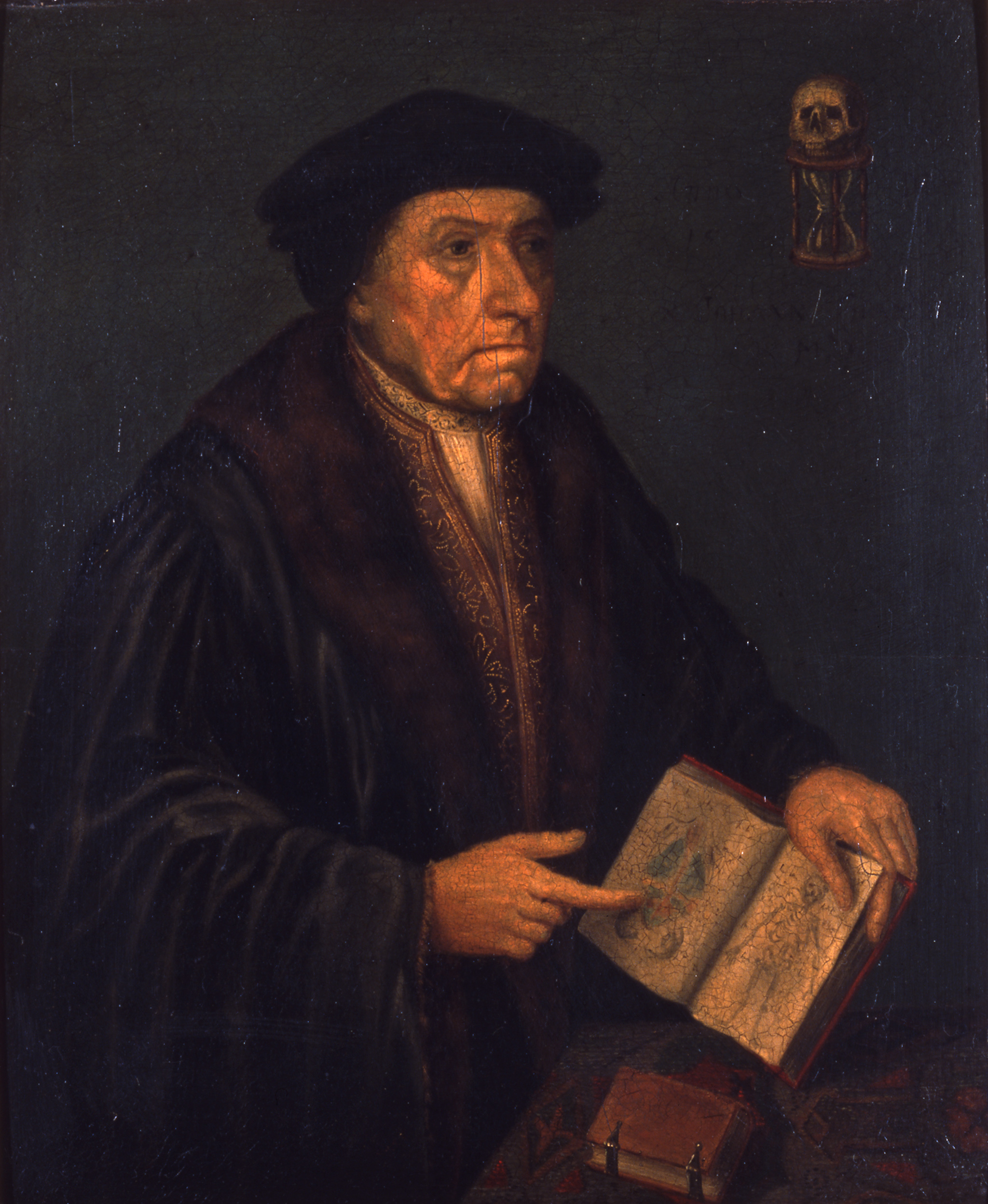 Three quarter size portrait of John Chambre. A man wearing 16th century clothing points to an open book.