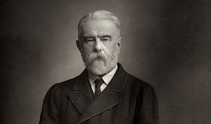 Black and white photograph of a white man with grey hair and a short beard.