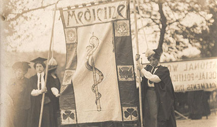 Black and white photograph of two women holding a banner reading 'Medicine'