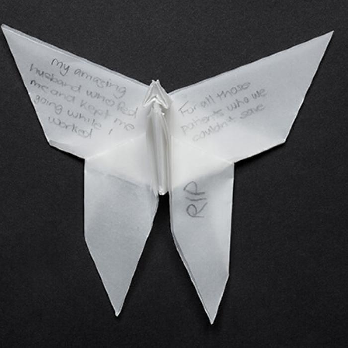 Origami butterfly with handwritten message on wing. RIP.