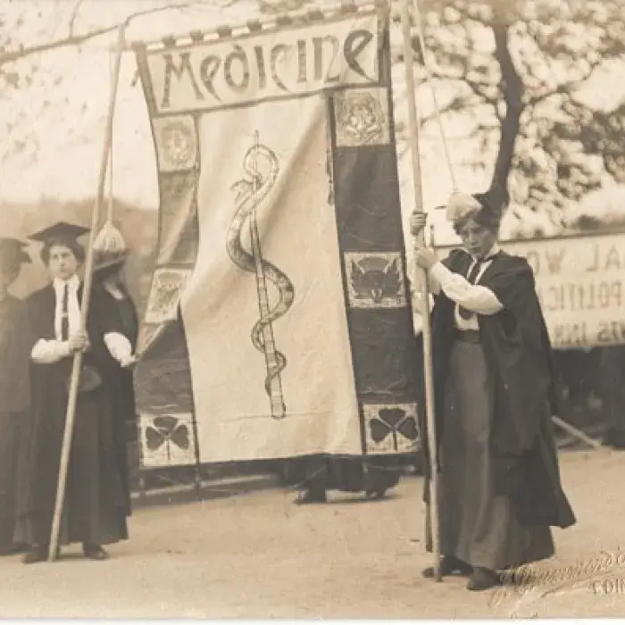 Photograph of suffragettes holding medicine banner