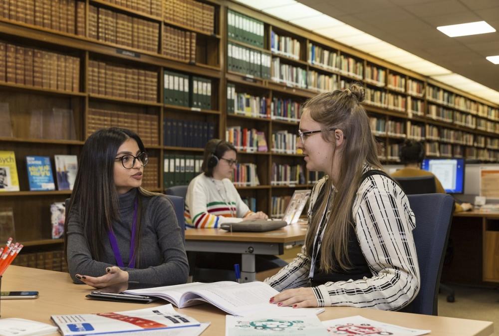Students working in library reading room